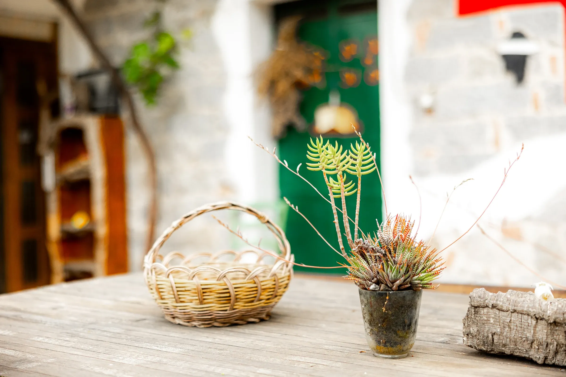 Small plant pots and a basket on the courtyard table